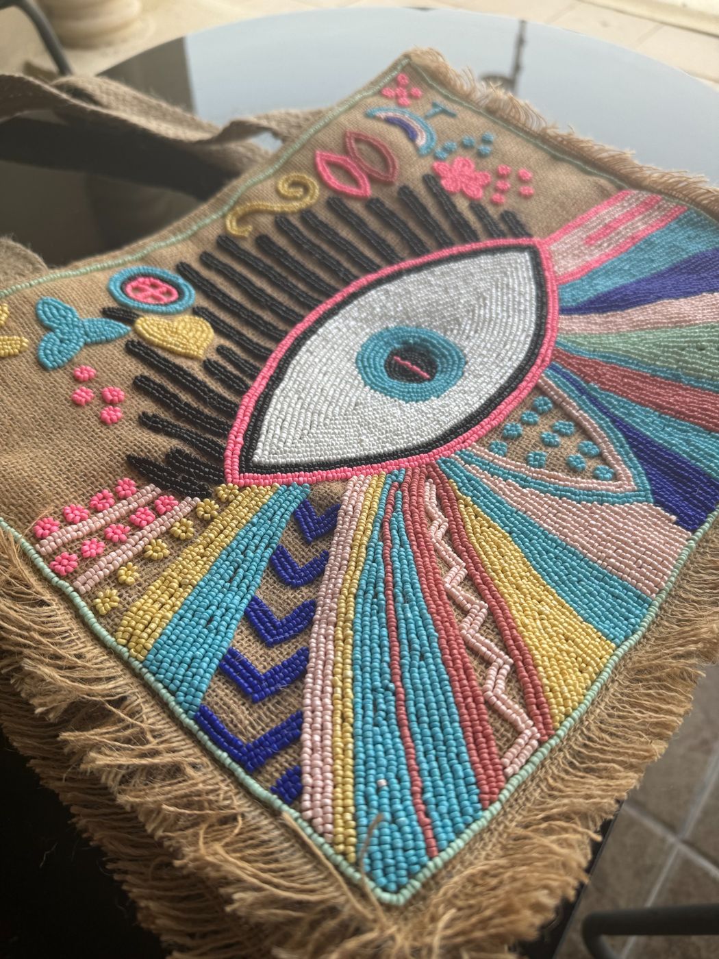 Hand-beaded evil-eye jute tote by Aztec Feather